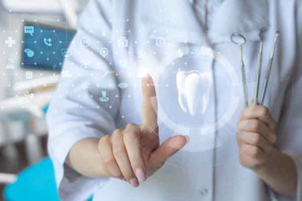 istock A dentist clicks on an icon of a tooth on a virtual screen . 2160442191
