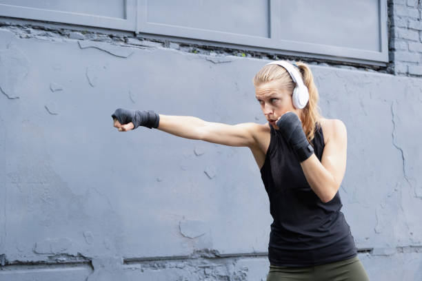 istock young female boxer training urban gray wall background 2160443623