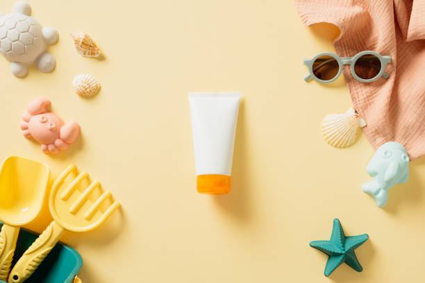 istock Vibrant summer beach collection on a sunny yellow background, featuring sunscreen, colorful towels, stylish sunglasses, and playful sea creature toys 2160444661