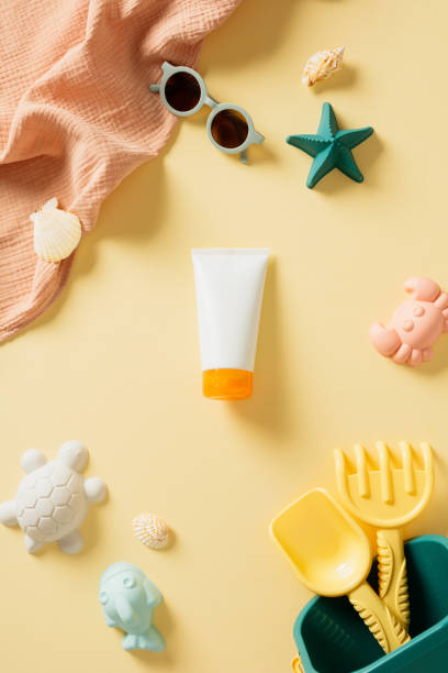 istock Vibrant summer essentials arranged on a sunny yellow background, featuring sunglasses, seashells, starfish, sunscreen, and playful beach toys 2160444750