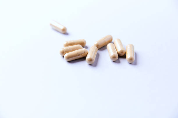 Ashwagandha (Withania somnifera) capsules. Paper background. Soft focus. Close up. Copy space.