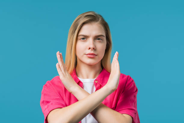istock No, never, young woman rejecting gesture stop crossing hands. Ban, timeout. 2160447556