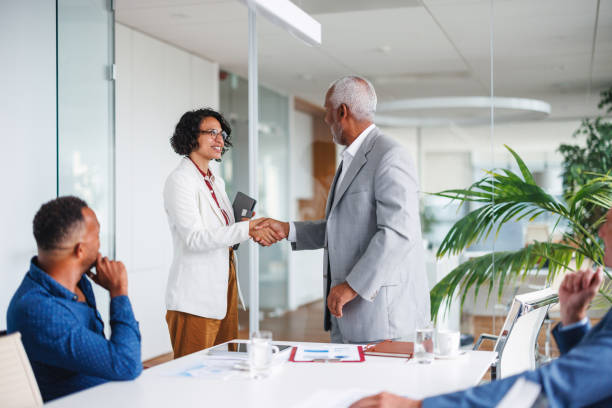 istock Diverse Business Team Shaking Hands in Office Meeting 2160450371