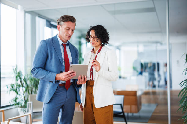 istock Caucasian and Multiracial Colleagues Discussing Work on Tablet in Office 2160450438