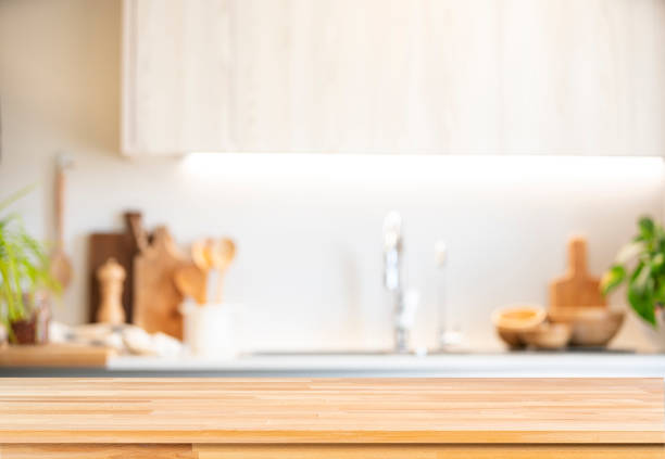 istock Empty wooden table with blurred kitchen at background. Ideal for product display 2160451131