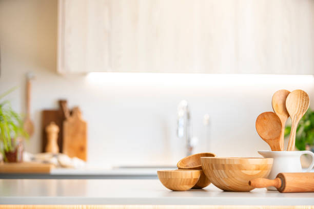 istock Kitchen counter with wooden bowls and kitchen utensils. Selective focus on foreground 2160451132