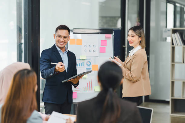 istock Professional diverse business team presenting and discussing data charts and graphs during meeting in modern office. 2160453814