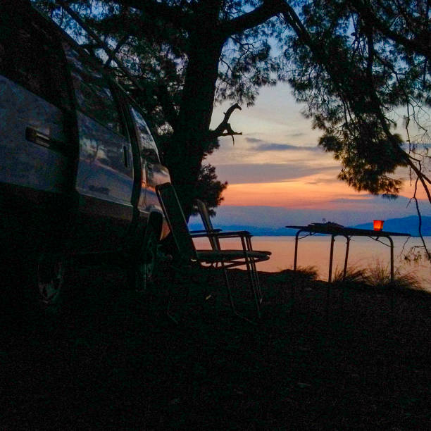 Camper and chairs on sea shore