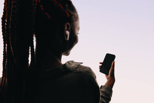 istock Young African woman using mobile phone for a video call 2160456035