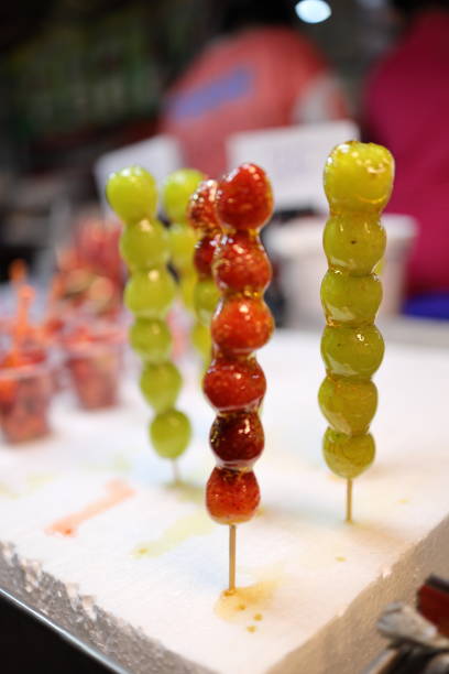 A vibrant display of candy apples and other festive treats at Berlin's Christmas market. Perfectly capturing the essence of holiday indulgence and seasonal joy