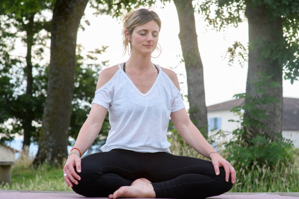 istock A young woman meditating in a public park 2160457108