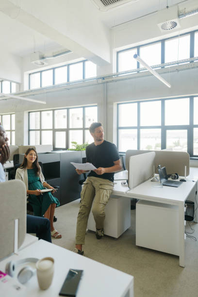 istock Coworkers discussing in the office 2160457500
