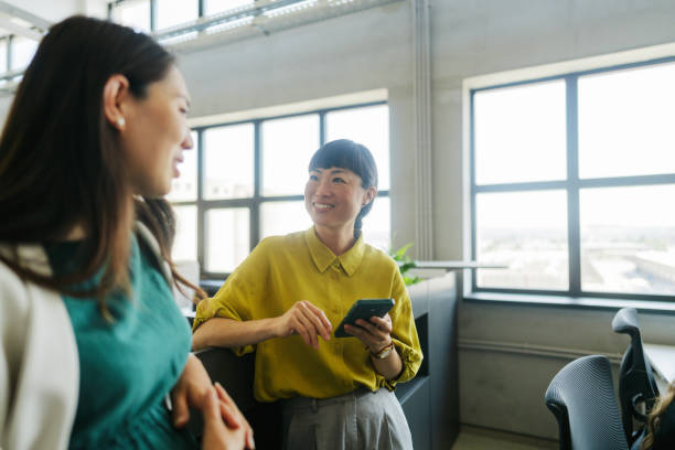 istock Coworkers discussing in the office 2160457518