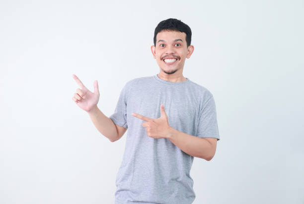 istock Happy Asian man is presenting something with hand point out to empty space. 2160457602