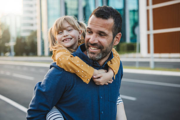 istock Father and daughter walking in the city. 2160457638