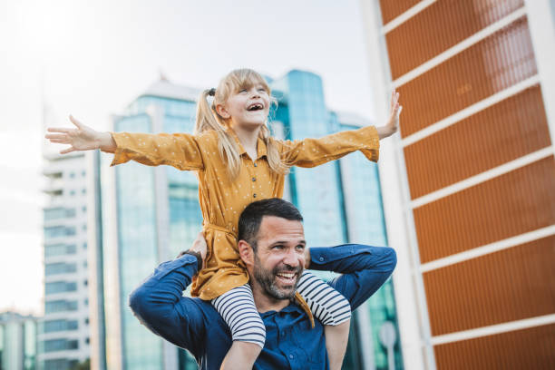 istock Father and daughter walking in the city. 2160457640