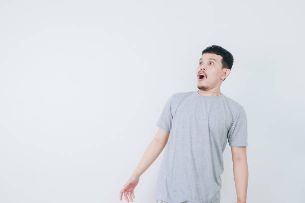 istock Surprised shocked face asian man isolated on white background for advertisement. 2160457654