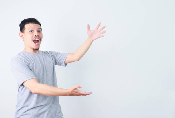 istock Happy Asian man is presenting something with hand point out to empty space. 2160457693