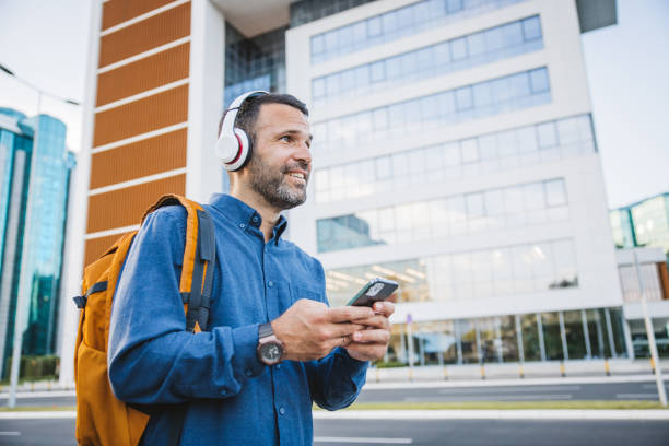 istock Handsome young businessman using smart phone 2160457705