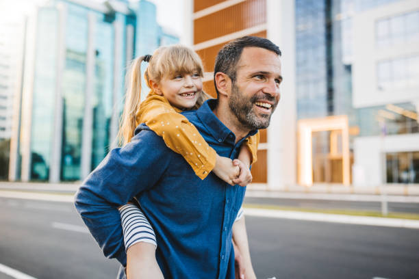 Father and daughter walking in the city.