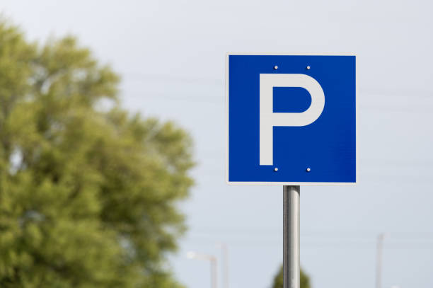Parking sign showing free places. Traffic parking sign with clean sky and light ray. Cars became biggest problem for urban ecology due emission Outdoors