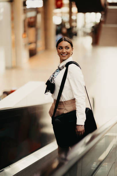 istock Empowered Latina businesswoman strides confidently through modern office. 2160459439