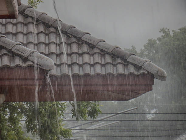 Water falling down from a roof during a rainstorm