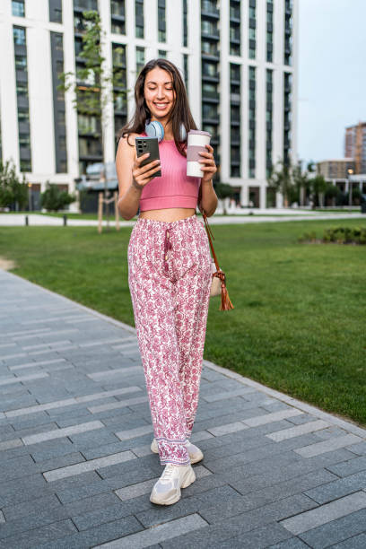 istock Young woman using phone in the city 2160461039