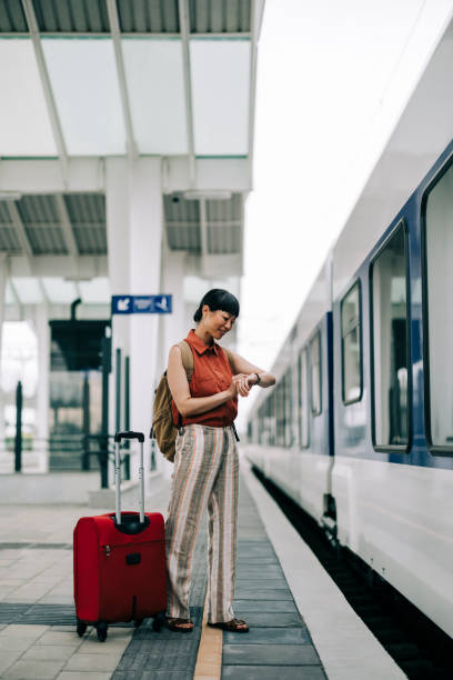 istock Asian  Woman Checking Time While Walking at Train Station 2160463694