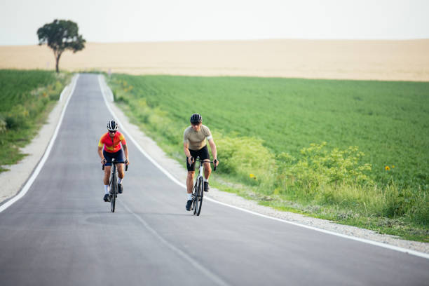 istock Cycling couple exercising on a empty rural road. 2160463785
