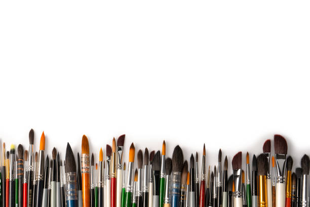 Mix of paint brushes in a row isolated on a white background.  Top view.
