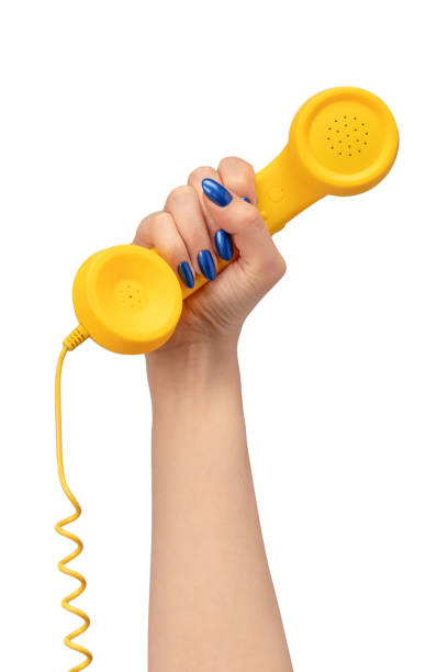istock Yellow handset in woman hand isolated on white. Copy space. 2160465372
