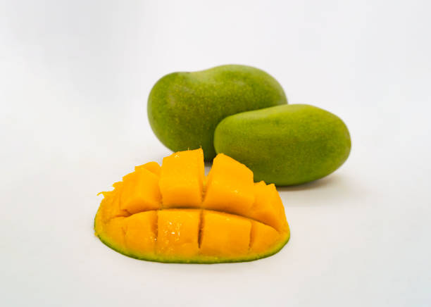 Delicious Looking Green Mangoes Chopped Tropical Fruit Cut Slices and Whole in a Basket Isolated White Background