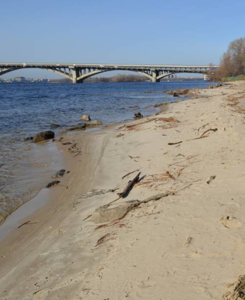 Bridge in Kyiv - Metropolitan across the Dnipro River, shore, sand, waves