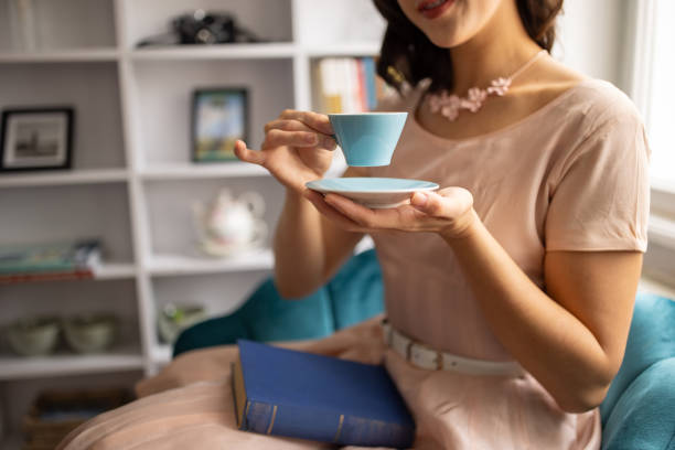 Classy young woman enjoying in tea alone in her modern apartment.