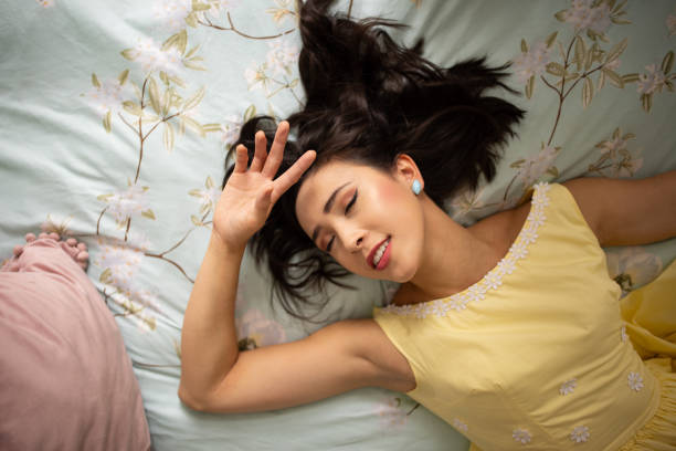 istock Beautiful woman lying on bed 2160470399
