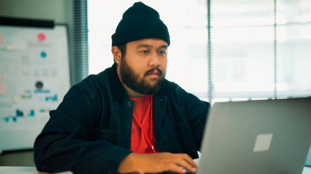 istock Young Asian man doing tasks with his laptop during a job interview. 2160470842