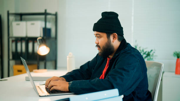 istock Young Asian man doing tasks with his laptop during a job interview. 2160470844