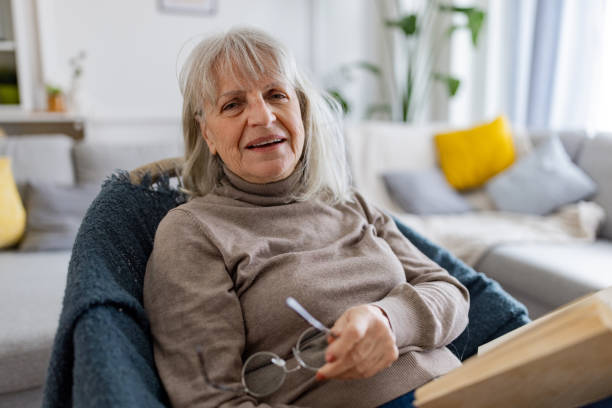 istock Elderly Woman Reading a Book 2160472804