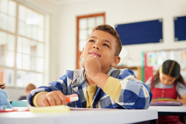 istock Little school boy thinking in classroom 2160474566