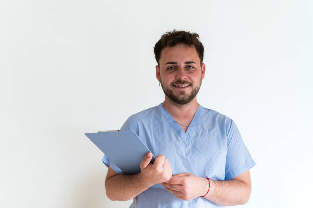 istock Young doctor with medical record smiling at camera 2160475746