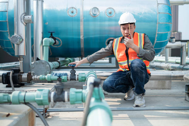istock Industrial Engineer Communicating via Walkie-Talkie on Site 2160475948