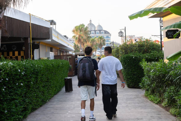 Two young friends walking along the hotel road