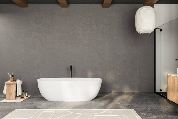 istock A bathroom with a white bathtub and a wooden stool. The room is empty and has a modern design 2160478415