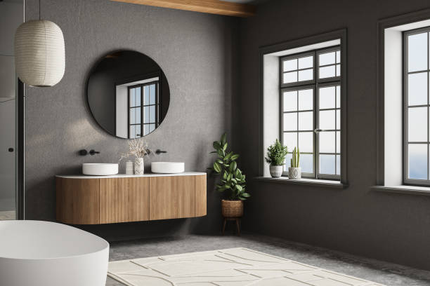 istock Modern bathroom design with a large mirror and two sinks. The mirror is surrounded by a wooden cabinet and a potted plant. The bathroom has a modern and sleek design 2160478438