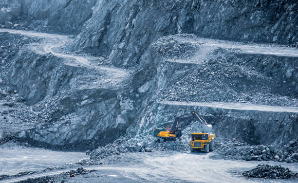 istock Excavator loading a dump truck in a multi-tiered diabase quarry in Parekklisia, Cyprus 2160478695