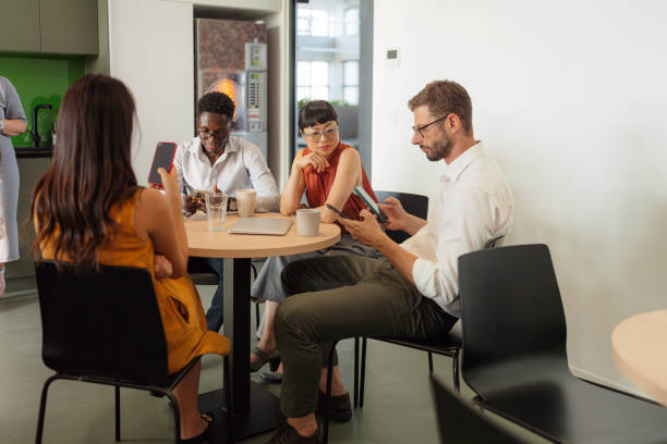 istock Colleagues taking a break in the office cafeteria 2160480495