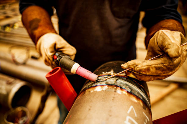 Metal welding. High temperature. Welder details. Creation of welding seam.
