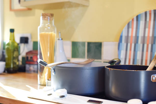 istock Cooking pasta in a home kitchen interior the pan has boiling water to cook spaghetti and raw ingredients on the kitchen counter 2160483204