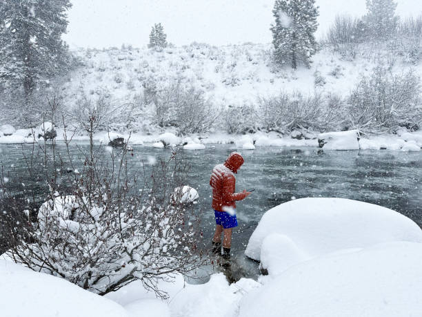 istock Father cold plunging in the snow and ice 2160485020